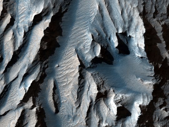 Tithonium Chasma (part of Mars' Valles Marineris) was cut with diagonal lines of sediment that could indicate ancient cycles of freezing and thawing, according to LiveScience.