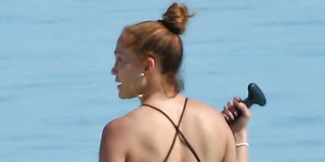 Jennifer Lopez hits the water in a black swimsuit with elegant straps